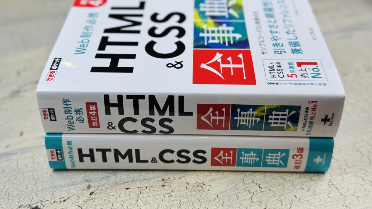 書籍「できるポケット HTML&CSS 全事典」改訂4版と改訂3版（前書）の厚さ比較。上が改訂4版、下が前書